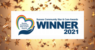 Image has graphic of heart rainbow and hand and text "Sussex Community Star & Care Awards, winner 2021" with gold background with stars to represent celebration