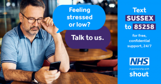 Image of a person looking at phone. Text reads "Felling stressed or low? Talk to us. Text Sussex to 85258 for free confidential support 24/7.