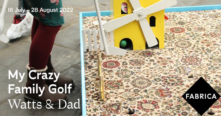 Close up photo of person's feet and legs and crazy golf set up with golf club and ball going into brightly coloured windmill