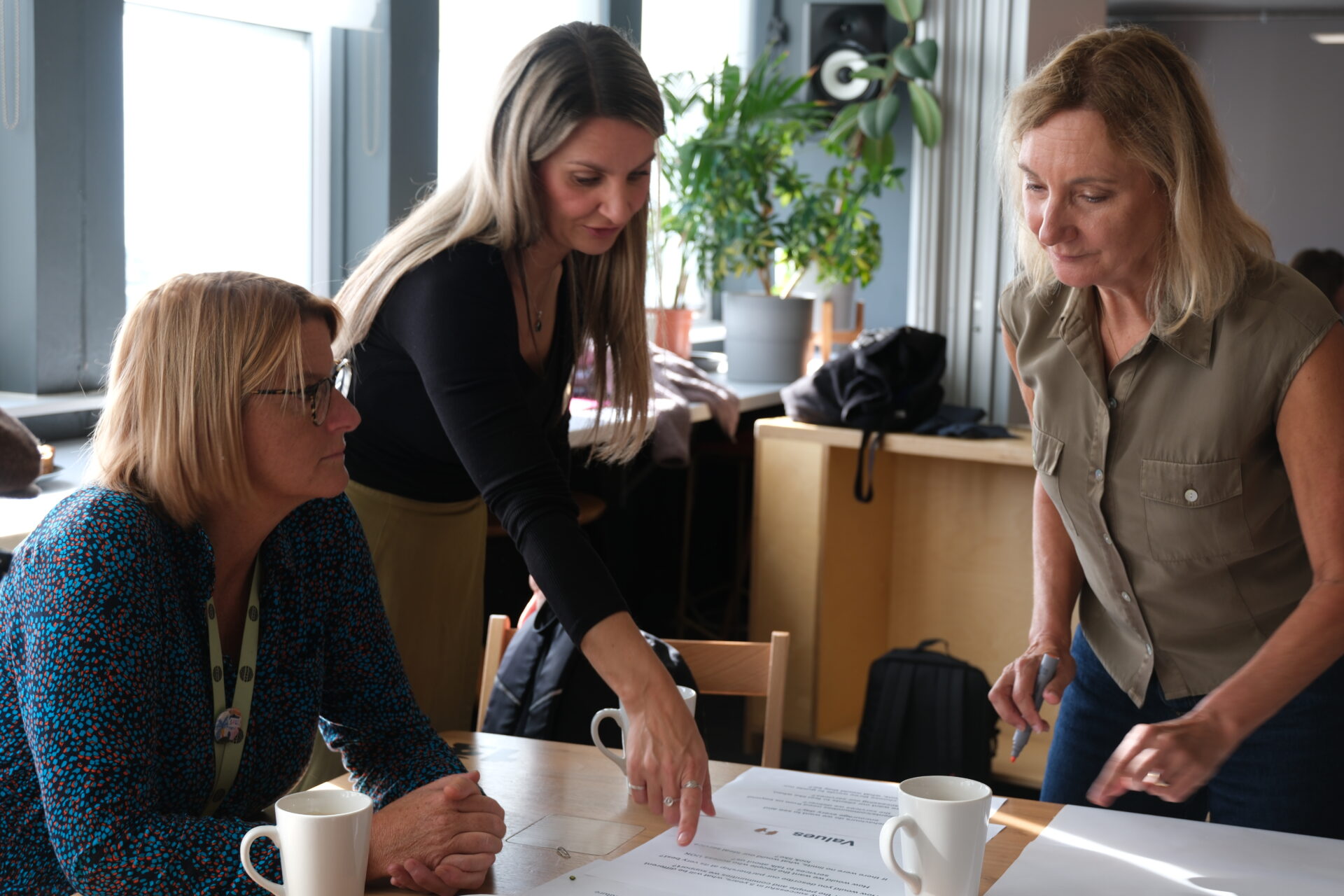 Three people working together collaboratively
